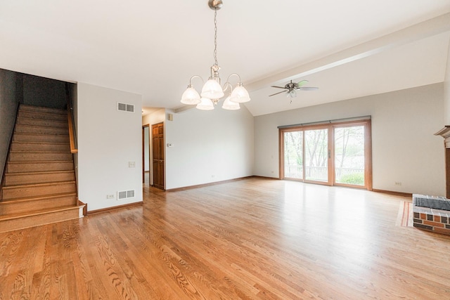 unfurnished living room featuring visible vents, light wood-style floors, and stairs