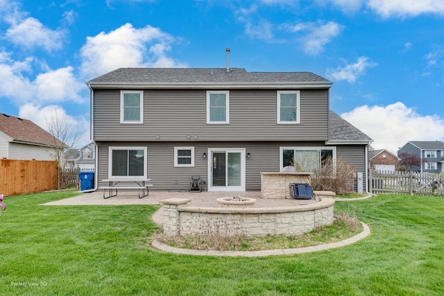 rear view of house with a fenced backyard, a yard, and a patio area