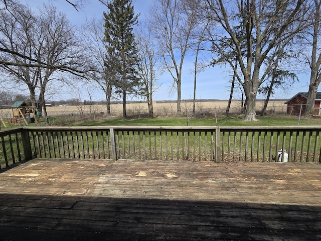 wooden deck featuring a playground