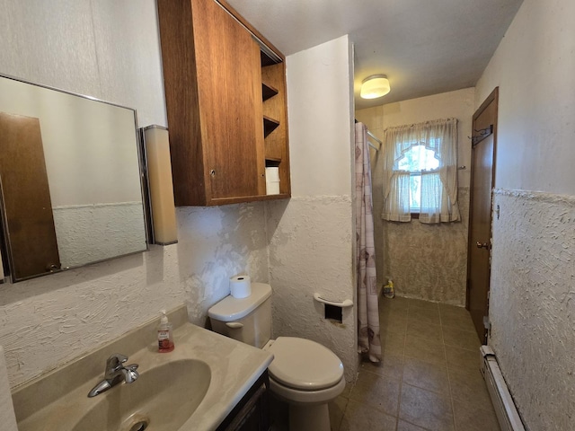 bathroom with baseboard heating, tile patterned floors, vanity, a shower with curtain, and toilet