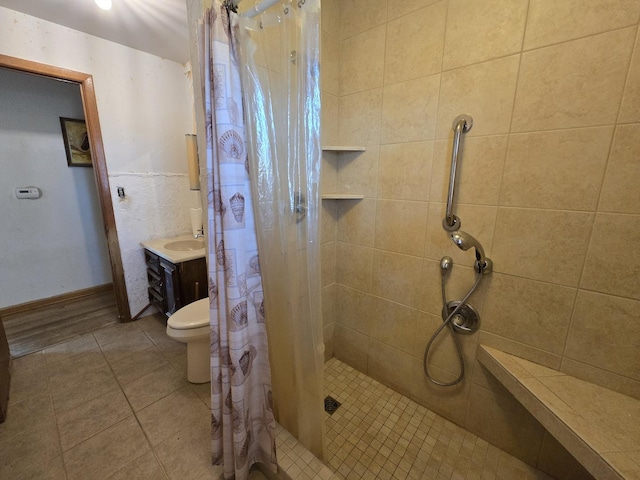 bathroom with vanity, toilet, a stall shower, and tile patterned floors