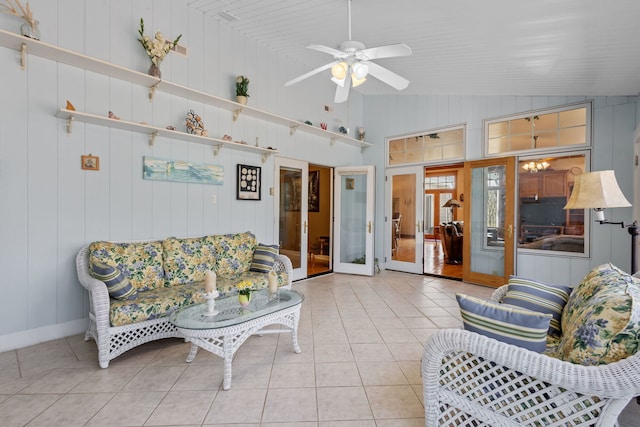 tiled living area with vaulted ceiling, french doors, and a ceiling fan