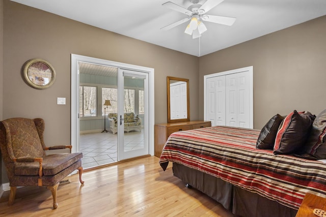 bedroom featuring light wood-style floors, access to outside, baseboards, and a closet