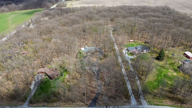 aerial view of property's location featuring a forest