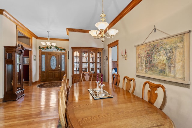 dining room featuring a chandelier, light wood-style floors, and ornamental molding