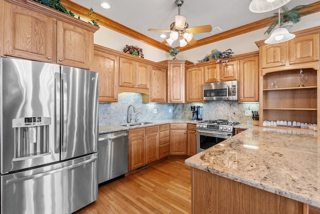 kitchen featuring appliances with stainless steel finishes, a sink, light stone counters, ornamental molding, and tasteful backsplash