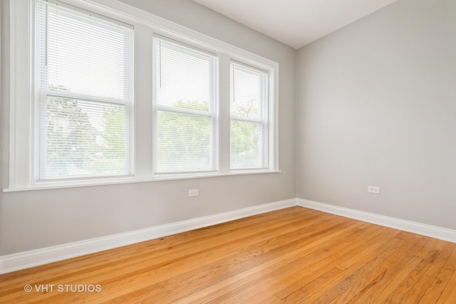 4449 W Sunnyside Ave Unit 2, Chicago, IL 60630 - spare room with baseboards and light wood finished floors
