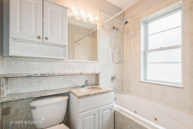 4449 W Sunnyside Ave Unit 2, Chicago, IL 60630 - full bath featuring a combined bath / shower with jetted tub, vanity, tile walls, plenty of natural light, and tasteful backsplash