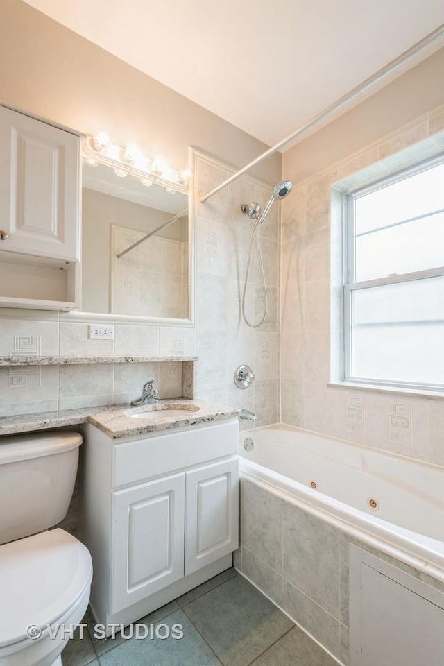 4449 W Sunnyside Ave Unit 2, Chicago, IL 60630 - full bath with tile patterned flooring, a combined bath / shower with jetted tub, and vanity