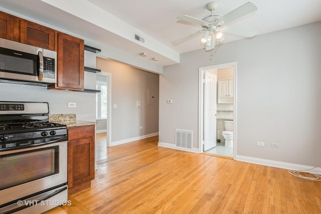 4449 W Sunnyside Ave Unit 2, Chicago, IL 60630 - kitchen with stainless steel appliances, light wood-style flooring, and ceiling fan