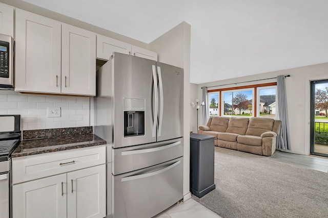 11007 W 167th St, Orland Park, IL 60467 - kitchen with stainless steel fridge, dark stone countertops, white cabinetry, open floor plan, and backsplash