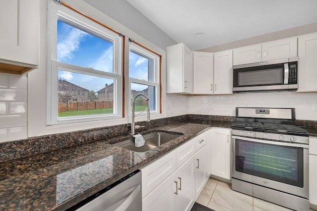 11007 W 167th St, Orland Park, IL 60467 - kitchen featuring a sink, dark stone counters, stainless steel appliances, white cabinetry, and backsplash