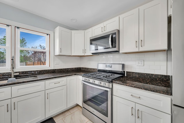 11007 W 167th St, Orland Park, IL 60467 - kitchen featuring decorative backsplash, appliances with stainless steel finishes, a sink, white cabinets, and dark stone countertops