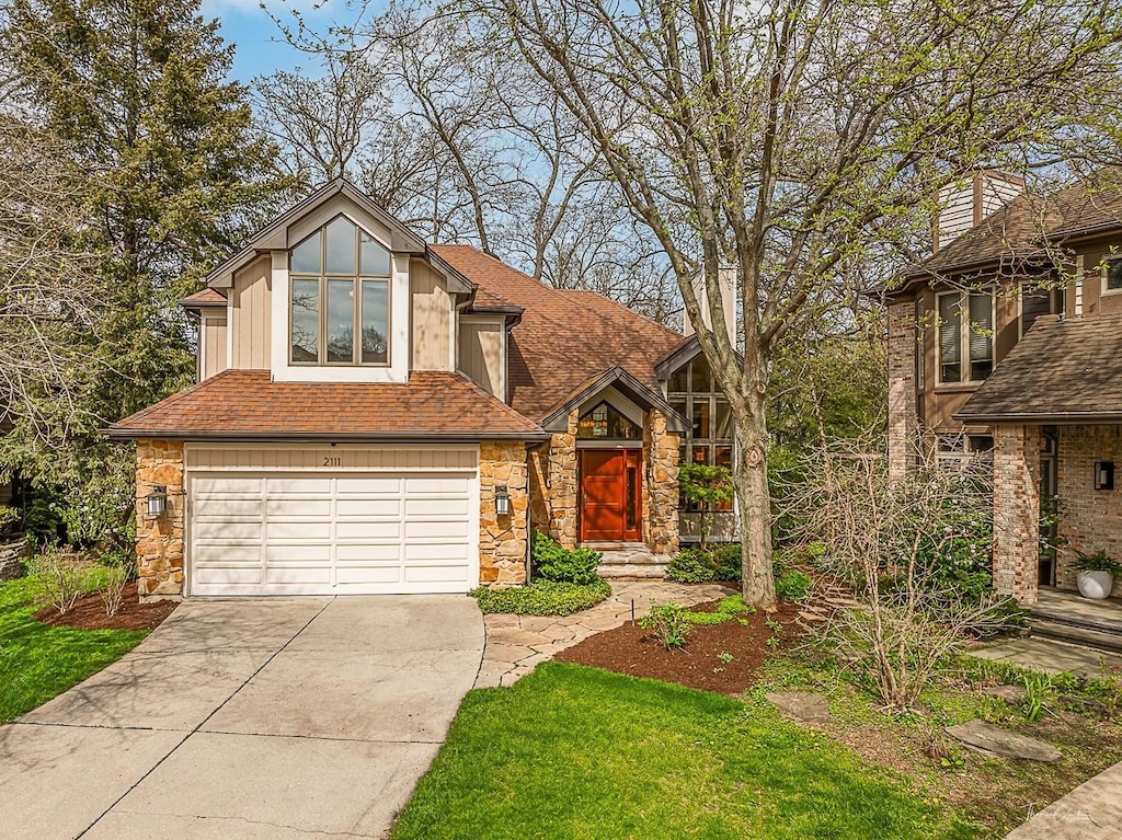 2111 Belleau Woods Ct, Wheaton, IL 60189 - view of front of property with roof with shingles, driveway, stone siding, and a garage