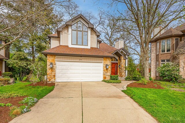 2111 Belleau Woods Ct, Wheaton, IL 60189 - view of front of property featuring a front lawn, stone siding, a chimney, an attached garage, and driveway