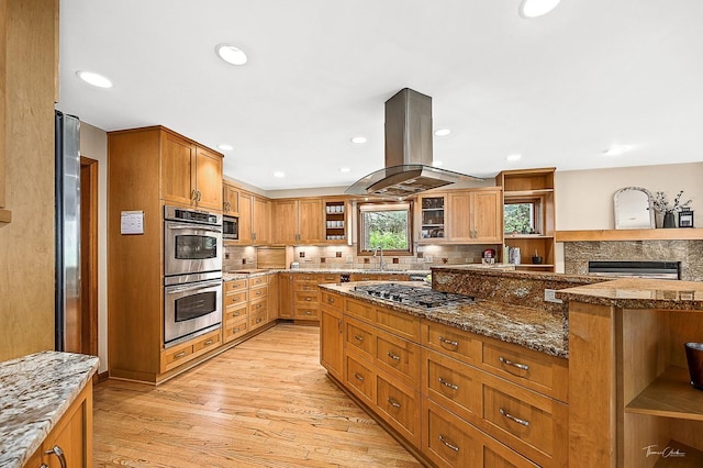 2111 Belleau Woods Ct, Wheaton, IL 60189 - kitchen featuring island exhaust hood, appliances with stainless steel finishes, tasteful backsplash, open shelves, and light wood-style flooring