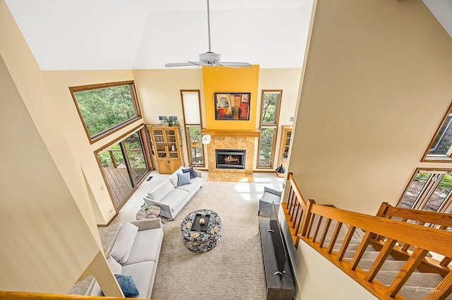 2111 Belleau Woods Ct, Wheaton, IL 60189 - carpeted living area with high vaulted ceiling, a lit fireplace, ceiling fan, and stairway