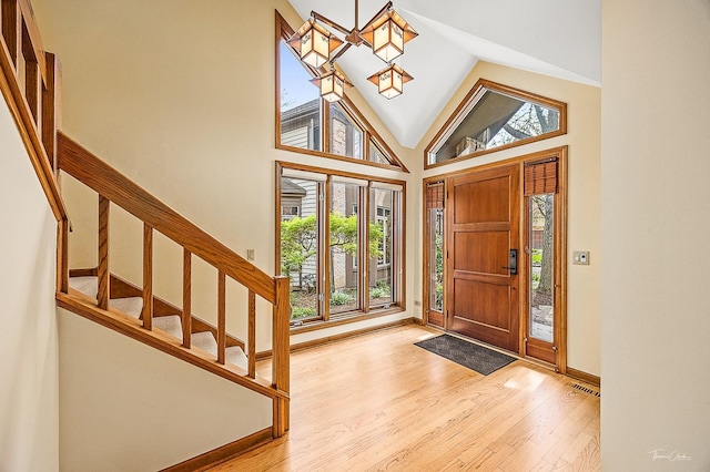 2111 Belleau Woods Ct, Wheaton, IL 60189 - foyer with visible vents, wood finished floors, baseboards, high vaulted ceiling, and stairway