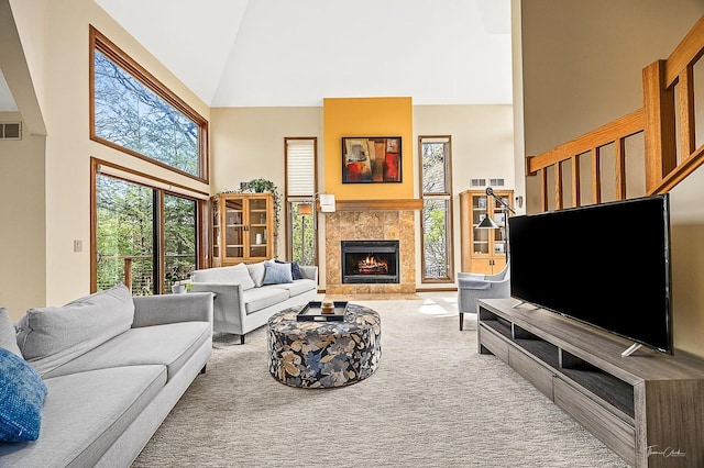 2111 Belleau Woods Ct, Wheaton, IL 60189 - carpeted living room featuring visible vents, a tiled fireplace, and high vaulted ceiling