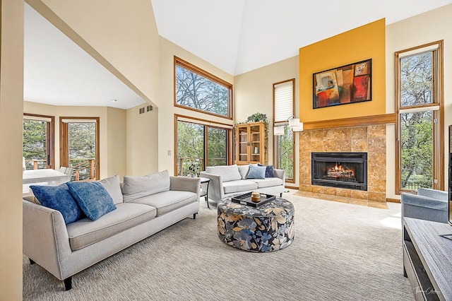 2111 Belleau Woods Ct, Wheaton, IL 60189 - living room featuring visible vents, a fireplace, carpet flooring, and a towering ceiling