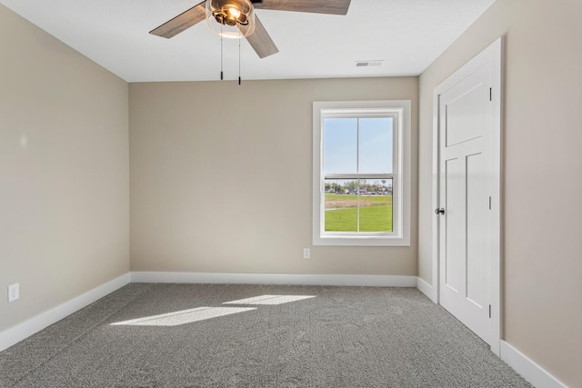unfurnished room featuring carpet floors, a ceiling fan, baseboards, and visible vents