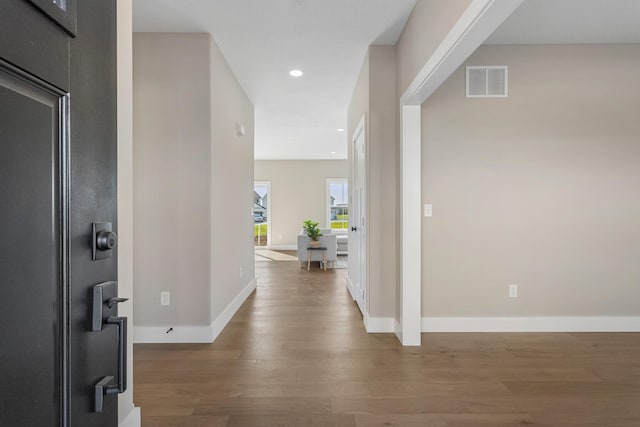 foyer featuring baseboards, recessed lighting, wood finished floors, and visible vents