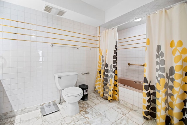 full bath featuring tile walls, marble finish floor, tiled shower / bath combo, toilet, and visible vents