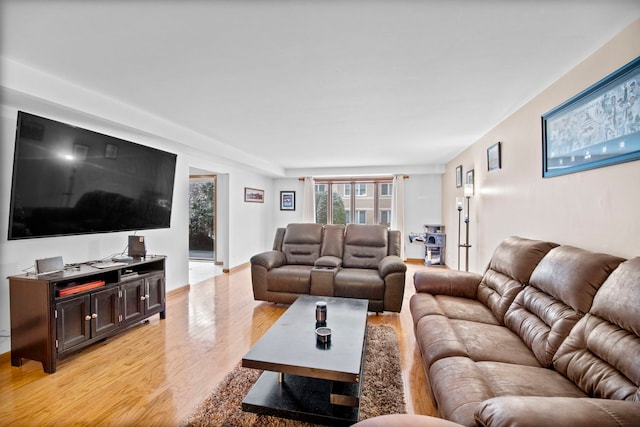 living room featuring baseboards and light wood-style floors