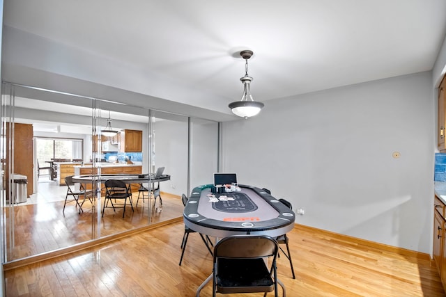 game room featuring light wood-style flooring and baseboards