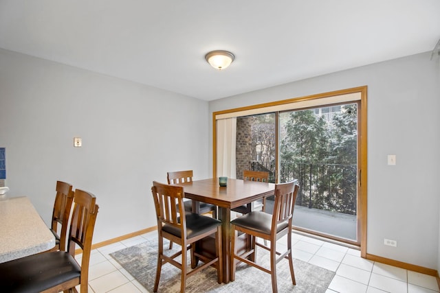 dining space featuring baseboards and light tile patterned floors