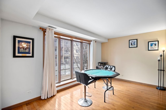 game room with light wood-type flooring, visible vents, and baseboards
