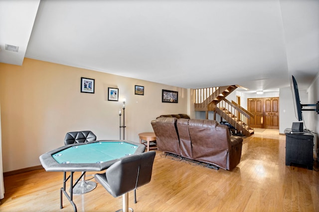 game room featuring baseboards, light wood-style floors, and visible vents