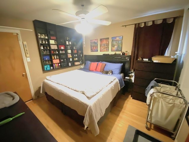 bedroom with ceiling fan and wood finished floors