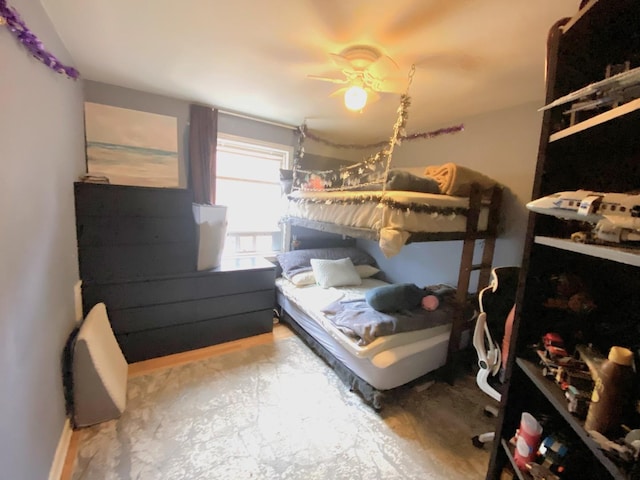 bedroom featuring baseboards and ceiling fan