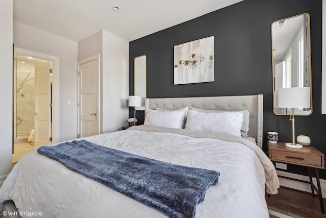 1448 W Chestnut St Unit 2, Chicago, IL 60642 - bedroom featuring baseboards, ensuite bath, and wood finished floors