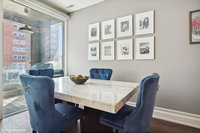 1448 W Chestnut St Unit 2, Chicago, IL 60642 - dining room featuring visible vents, baseboards, and wood finished floors