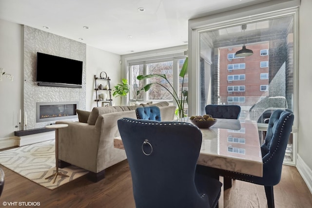 1448 W Chestnut St Unit 2, Chicago, IL 60642 - dining area featuring baseboards, wood finished floors, and a fireplace