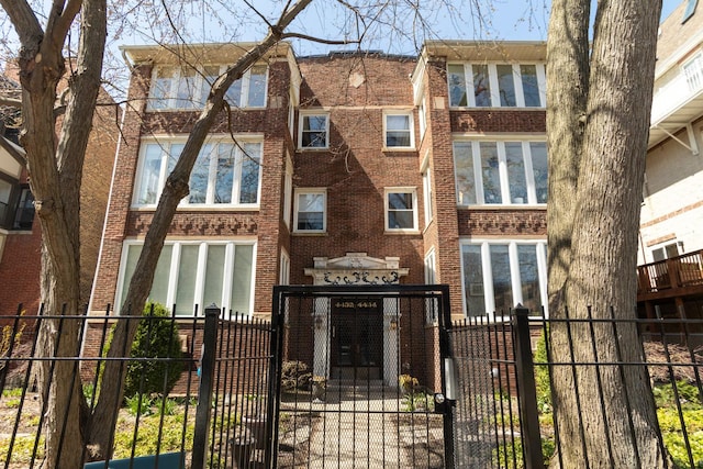 4432 N Racine Ave Unit 3S, Chicago, IL 60640 - view of front of property with a fenced front yard, brick siding, and a gate