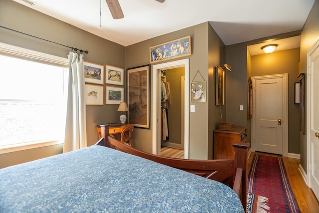 4432 N Racine Ave Unit 3S, Chicago, IL 60640 - bedroom featuring a spacious closet, a ceiling fan, multiple windows, and wood finished floors