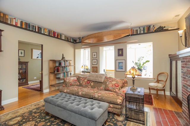 4432 N Racine Ave Unit 3S, Chicago, IL 60640 - living area with a fireplace, baseboards, a healthy amount of sunlight, and wood finished floors