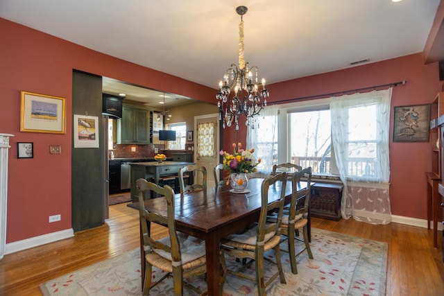4432 N Racine Ave Unit 3S, Chicago, IL 60640 - dining room with baseboards, light wood-type flooring, and a healthy amount of sunlight