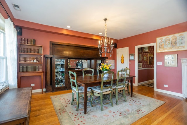4432 N Racine Ave Unit 3S, Chicago, IL 60640 - dining space featuring wood finished floors, visible vents, recessed lighting, a chandelier, and baseboards