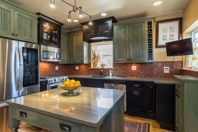 4432 N Racine Ave Unit 3S, Chicago, IL 60640 - kitchen with green cabinets, a sink, dark stone countertops, stainless steel appliances, and light wood-type flooring