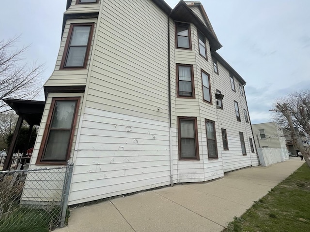 view of side of property featuring fence