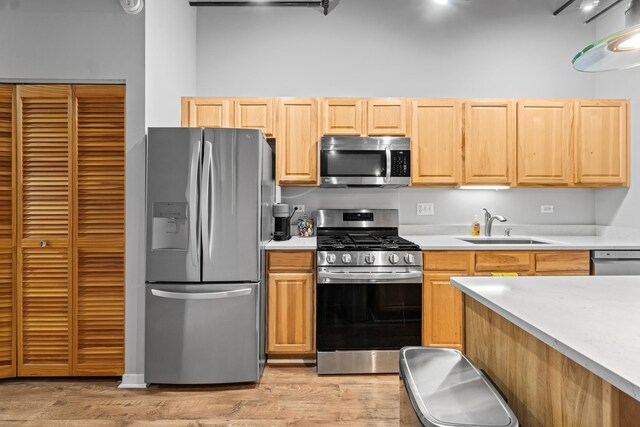 1740 N Maplewood Ave Unit 102, Chicago, IL 60647 - kitchen with light countertops, light brown cabinetry, stainless steel appliances, and a sink