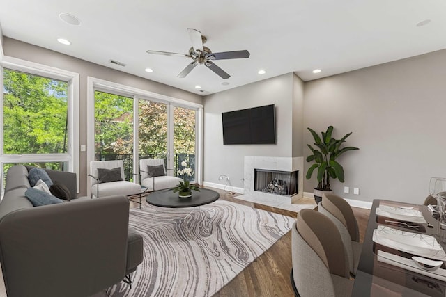 2259 W Wabansia Ave Unit 309, Chicago, IL 60647 - living area with wood finished floors, a ceiling fan, baseboards, a fireplace with flush hearth, and recessed lighting