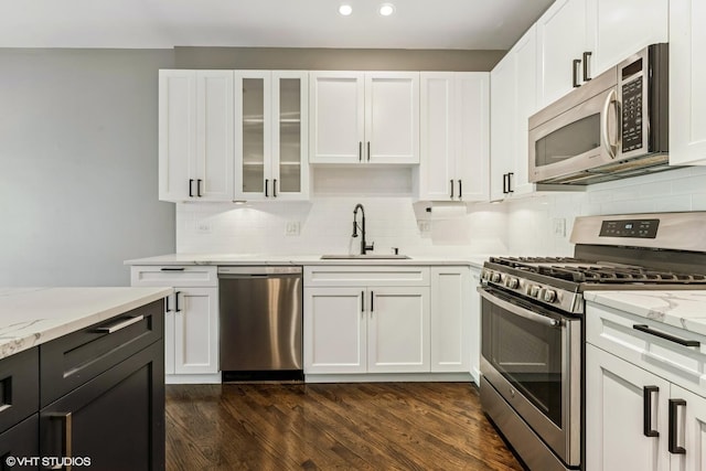 2259 W Wabansia Ave Unit 309, Chicago, IL 60647 - kitchen with stainless steel appliances, a sink, white cabinetry, light stone counters, and recessed lighting