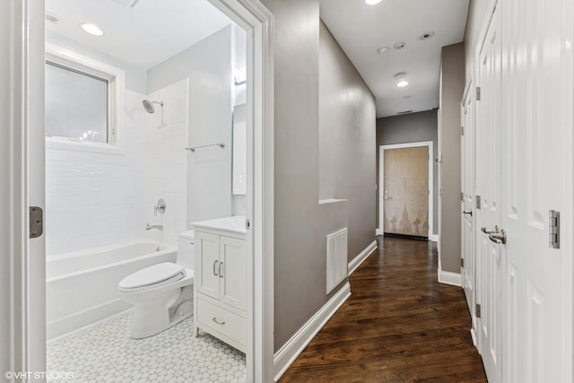 2259 W Wabansia Ave Unit 309, Chicago, IL 60647 - bathroom featuring toilet, vanity, shower / bathtub combination, baseboards, and wood finished floors