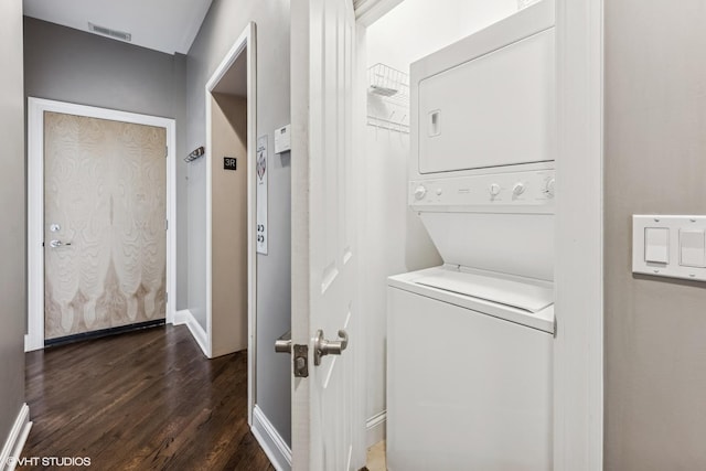 2259 W Wabansia Ave Unit 309, Chicago, IL 60647 - laundry room with stacked washing machine and dryer, dark wood-type flooring, and baseboards