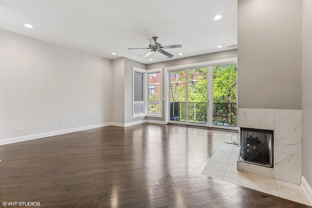 2259 W Wabansia Ave Unit 309, Chicago, IL 60647 - unfurnished living room with ceiling fan, baseboards, wood finished floors, a fireplace, and recessed lighting